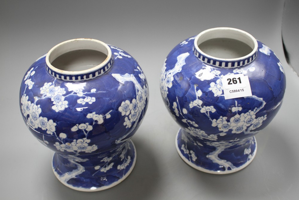 A pair of late 19th century Chinese prunus pattern baluster vases and covers, height 29cm